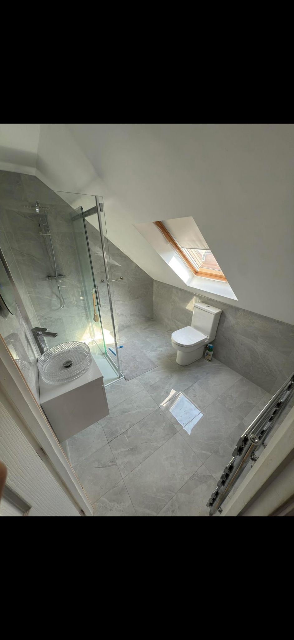 Loft bathroom with grey marble tiling and walk-in shower, Cardiff