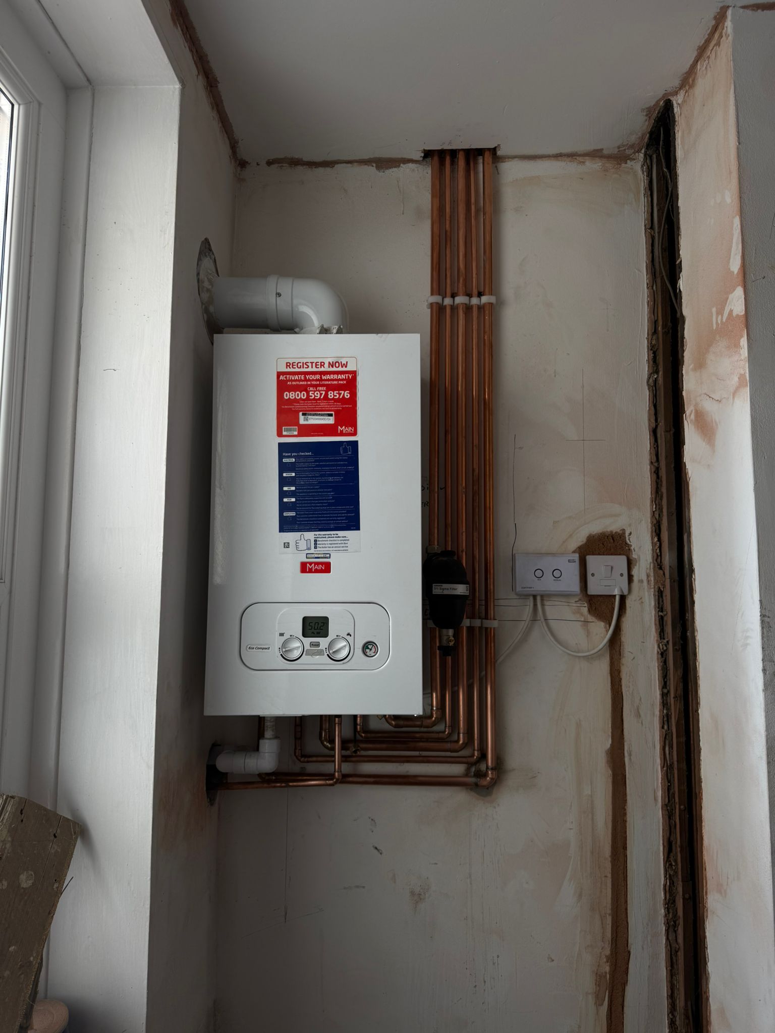 Neat Main combi boiler installation with tidy copper pipework, Cardiff